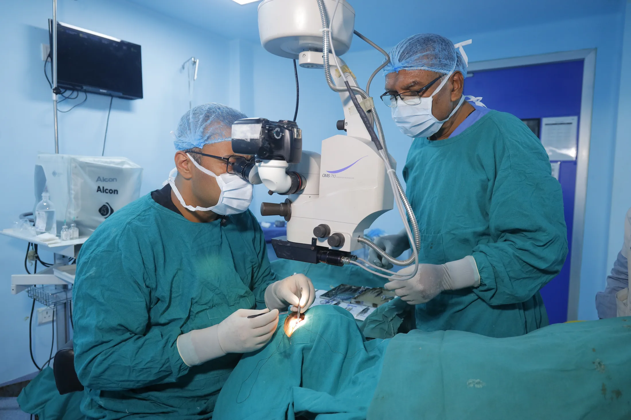 Ophthalmic surgical team working at an operating microscope